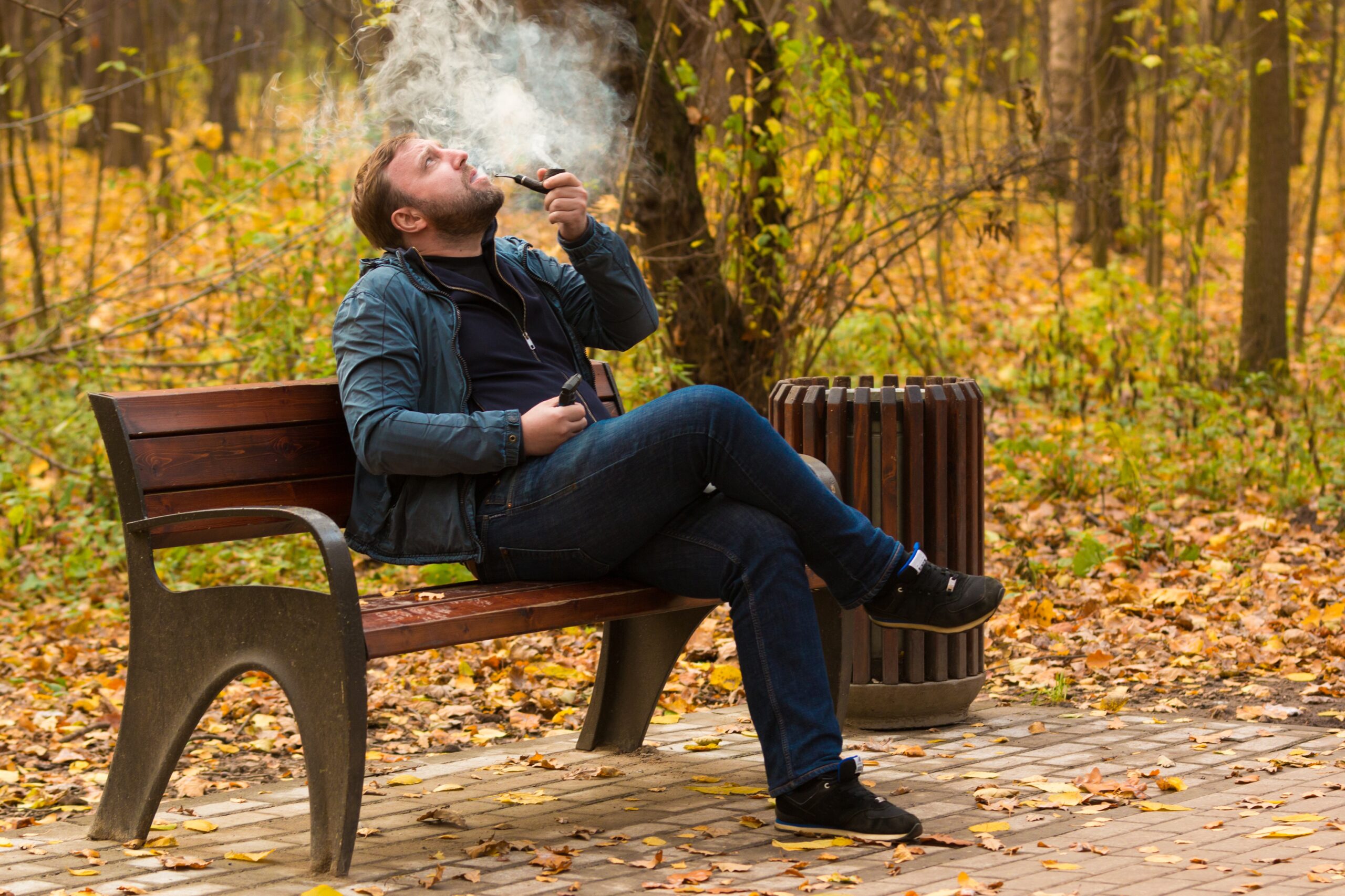 A man smoking weed on a bench
