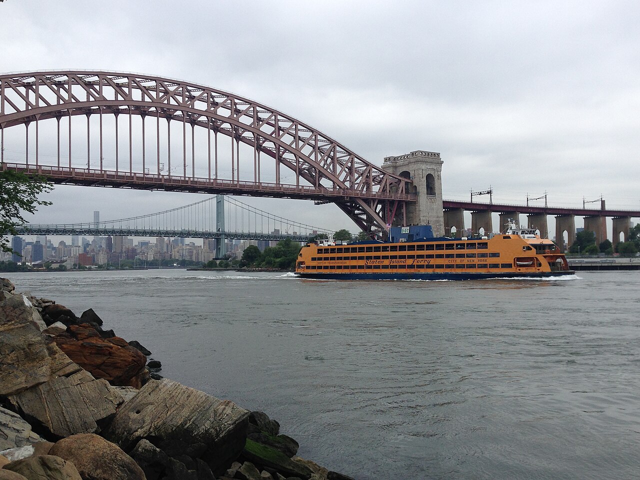 The MV Samuel I. Newhouse on the East River, with the Hell Gate and Triboro bridges behind it