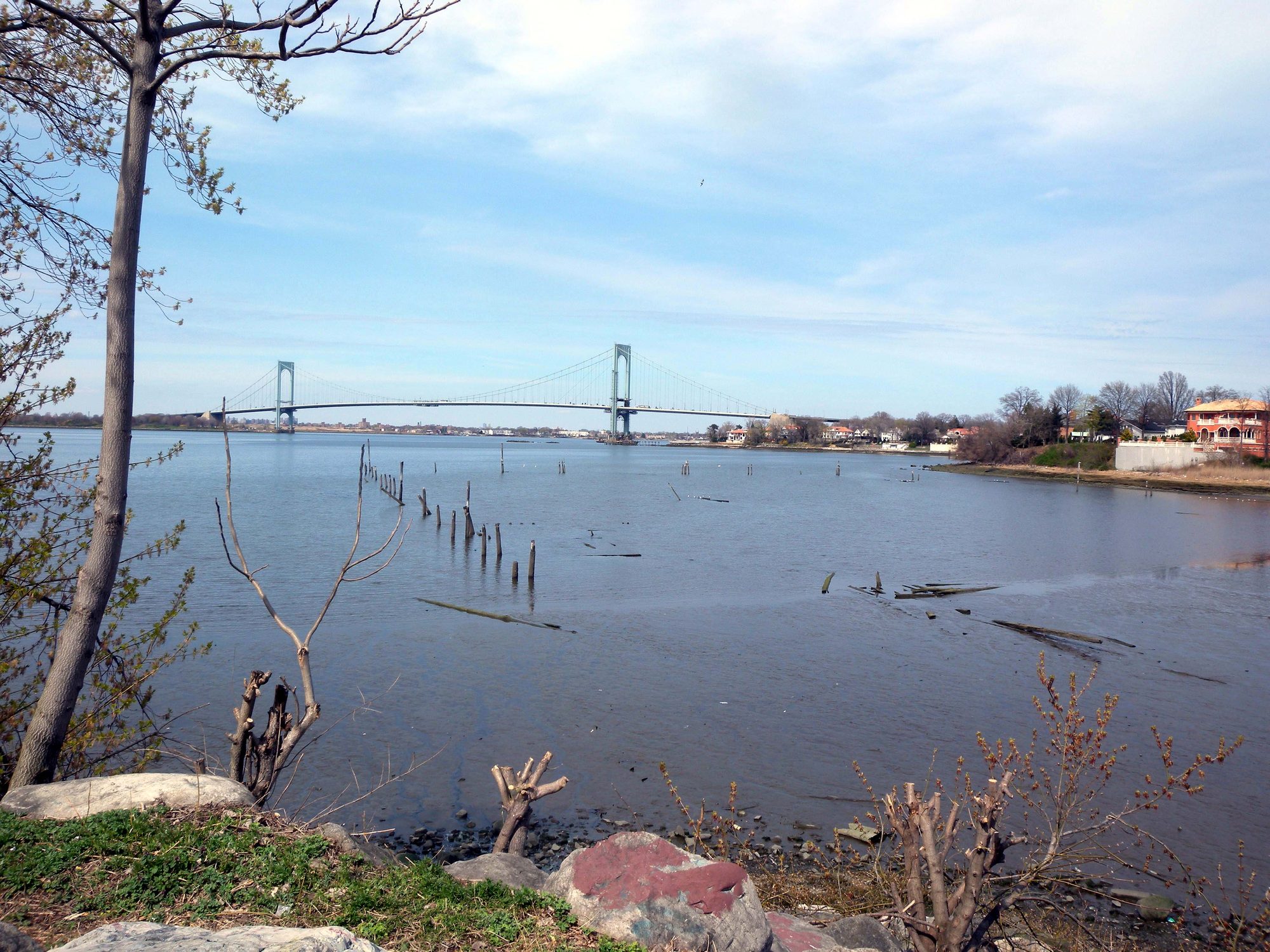 Powell's Cove waterfront in College Point, Queens, with a bridge in the background