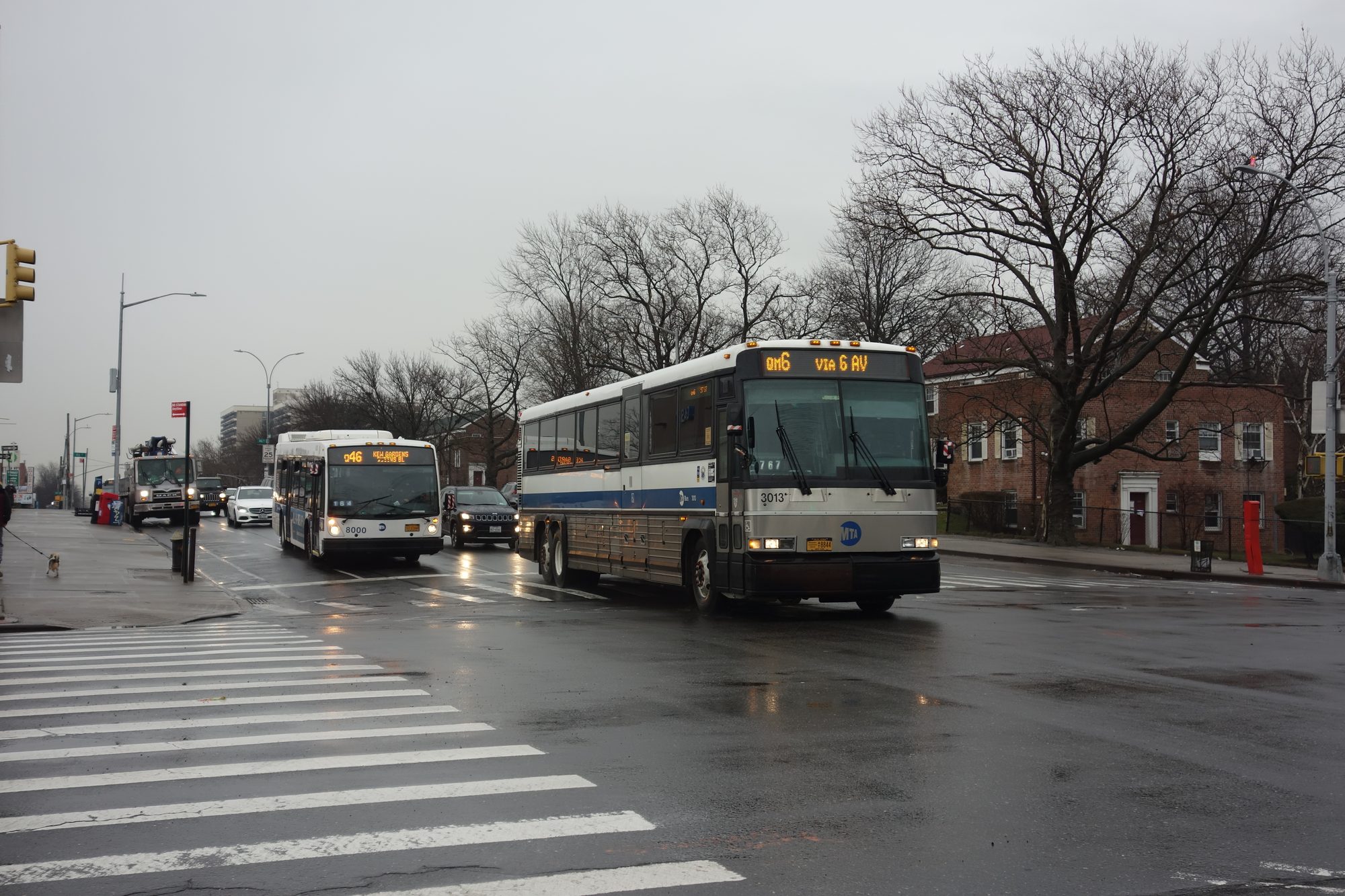 A Q46 bus and a QM6 express bus at Union Turnpike and Main Street in Kew Gardens Hills, Queens.